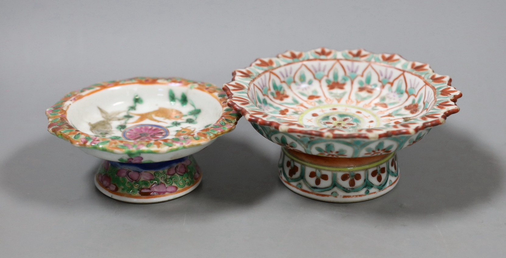 A Chinese Straits enamelled porcelain stem dish, together with a smaller footed koi famille rose stem dish, both late 19th/early 20th century, Largest 12cm diameter